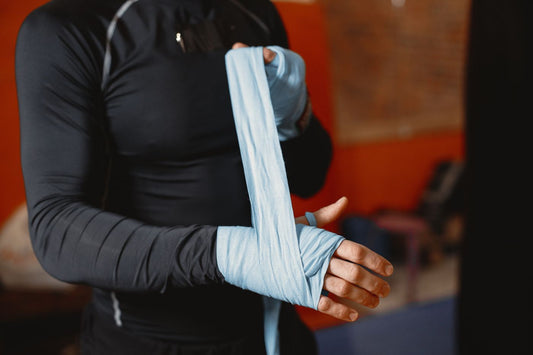 Boxer wrapping a hand wrap around the wrist and forearm