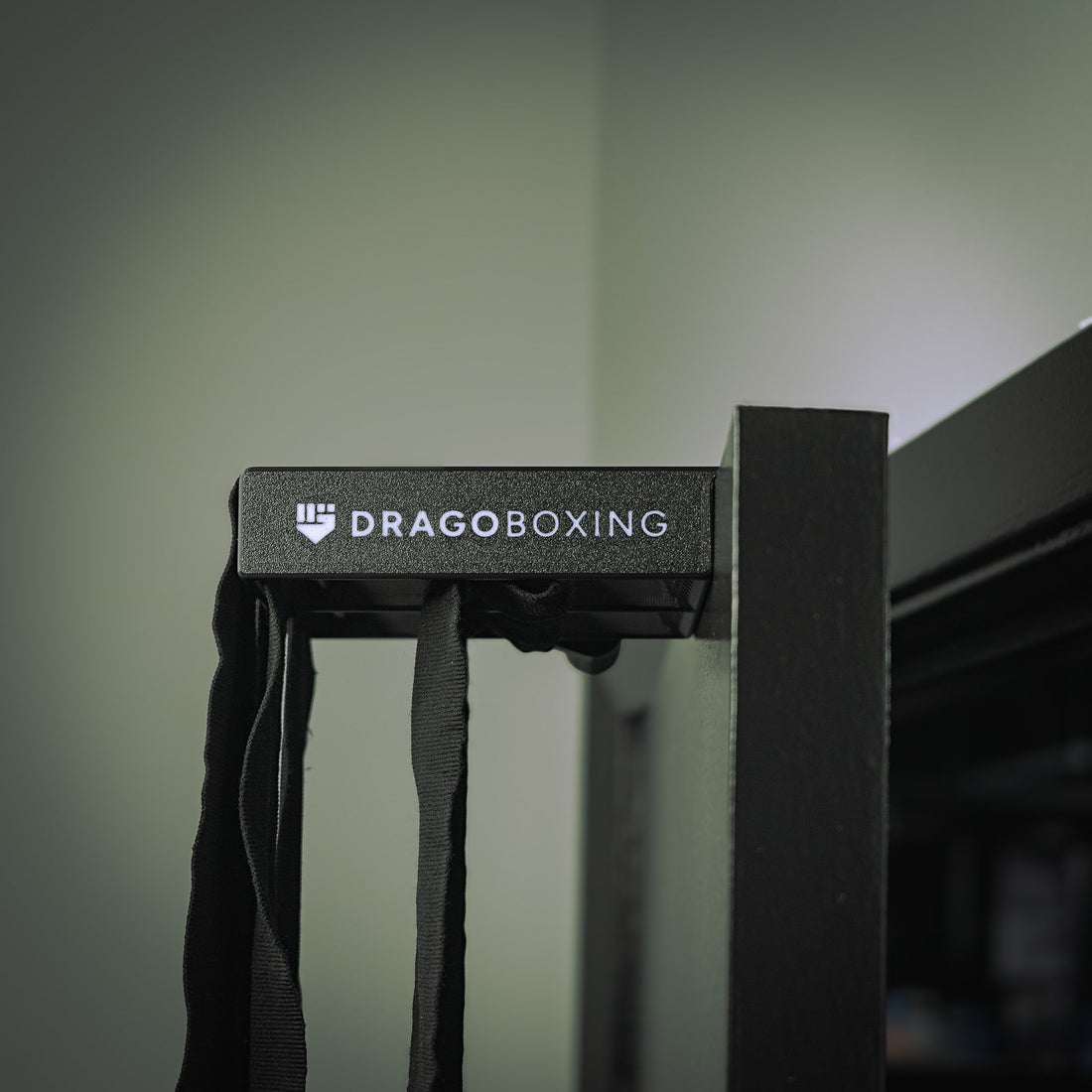 Drago Roller clipped over an apartment door with black hand wraps hanging down to air dry