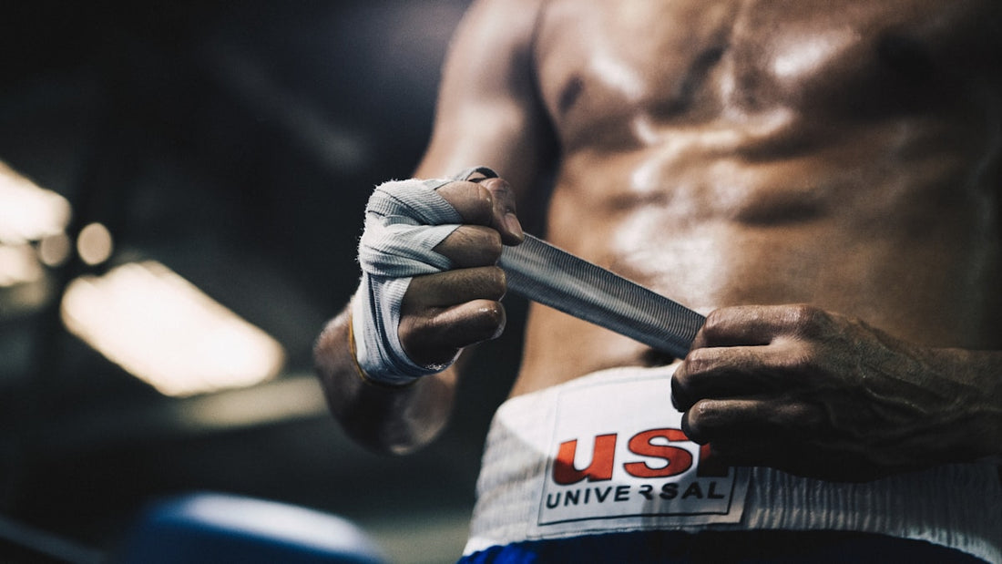 Fighter wrapping hands with boxing hand wraps before training