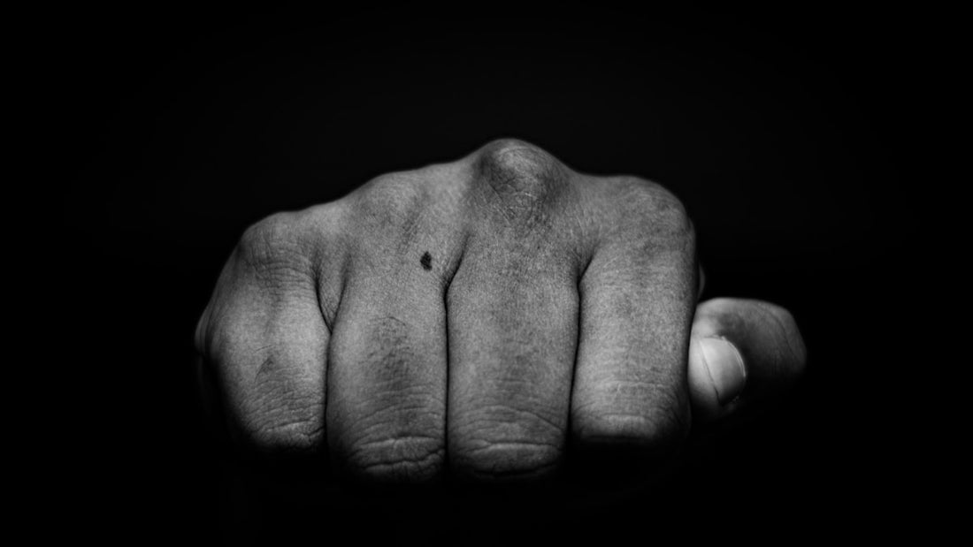 Close-up black and white photograph of a clenched fist