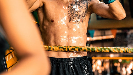 Sweaty boxer in ring taking a water break