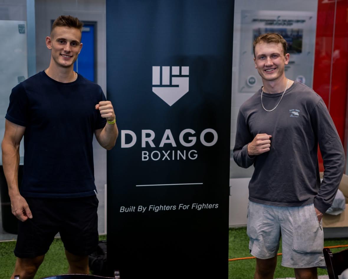 Drago Boxing founders Shane McCarthy and Luke Richardson beside the Drago Boxing banner