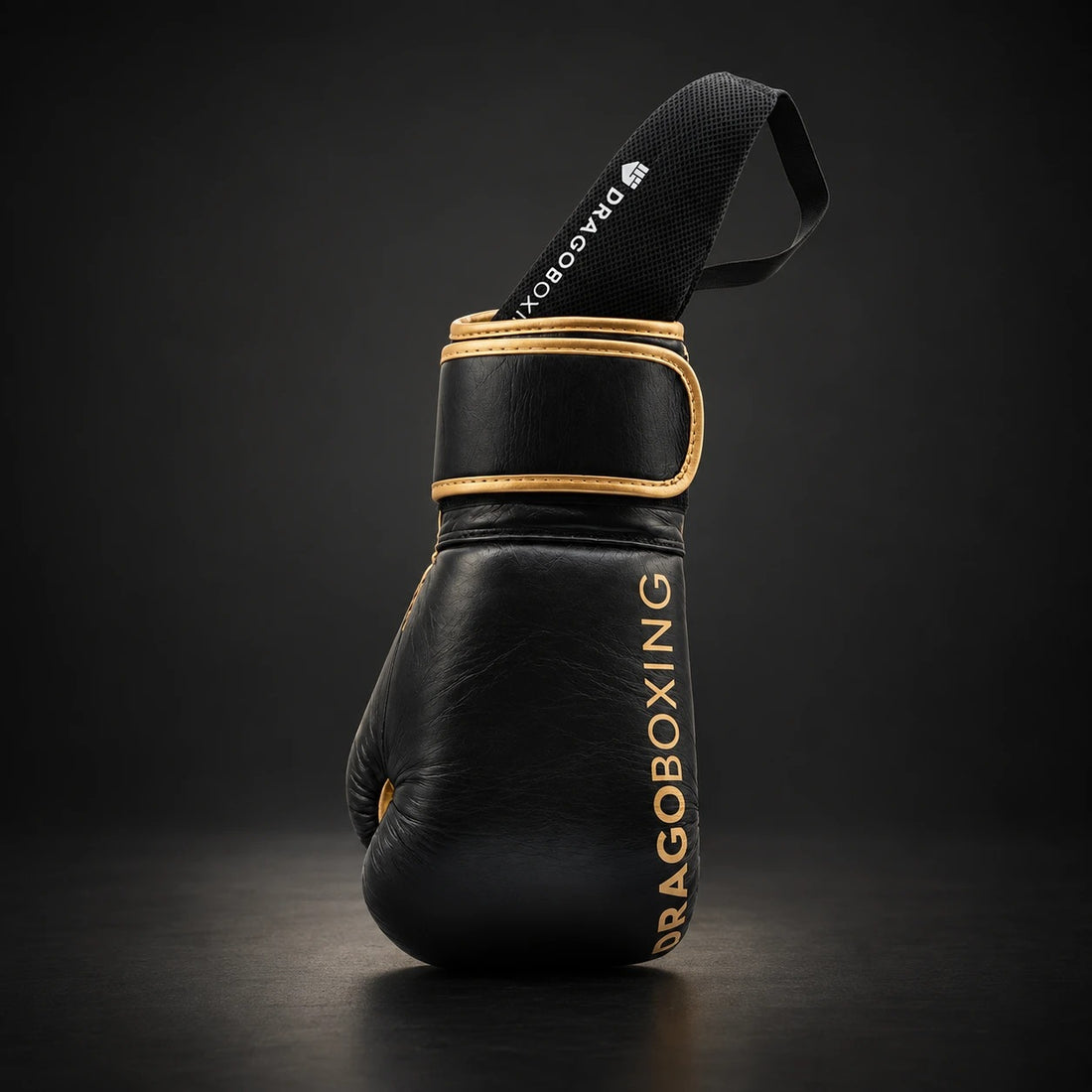 Drago glove deodorizer tucked inside a black and gold Drago boxing glove, strap out of the cuff