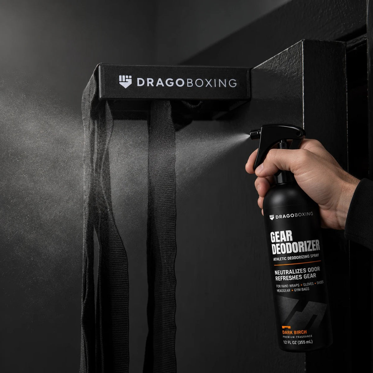 Spraying Gear Deodorizer on hand wraps hanging on the Drago Roller